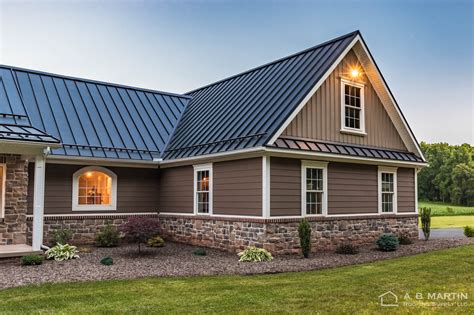 grey house with brown metal roof|black roof with gray siding.